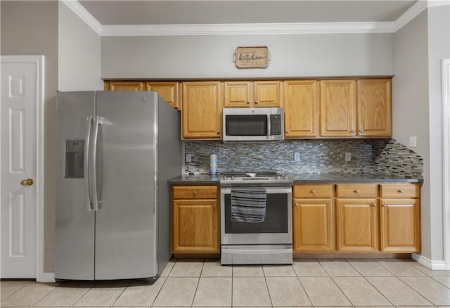 kitchen with dark countertops, light tile patterned floors, and stainless steel appliances