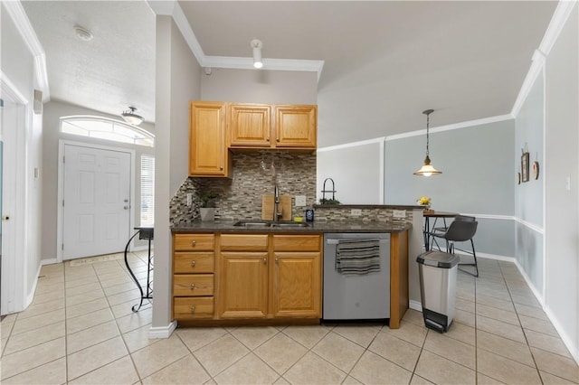 kitchen featuring light tile patterned flooring, crown molding, dark countertops, and stainless steel dishwasher