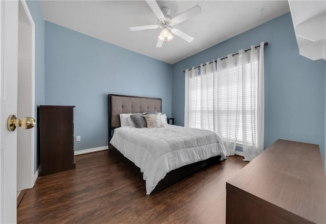 bedroom with dark wood-type flooring, baseboards, and ceiling fan