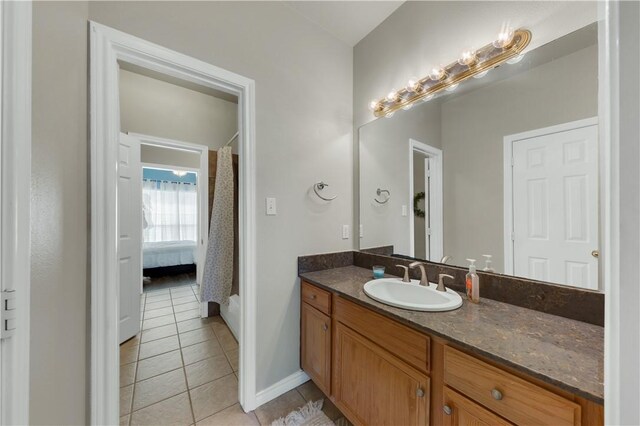 full bathroom with tile patterned floors, vanity, and baseboards