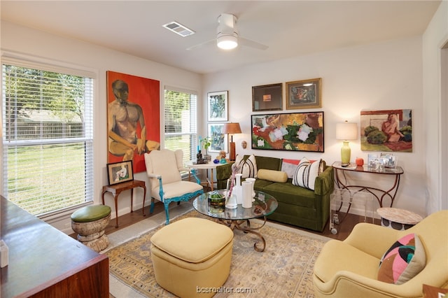 sitting room with ceiling fan and light hardwood / wood-style flooring