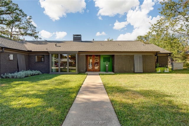 view of front facade with a front lawn, french doors, and central air condition unit