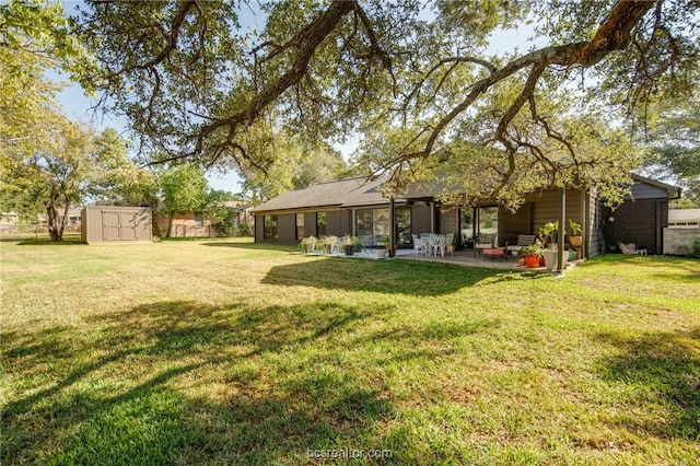 view of yard featuring a storage unit and a patio area