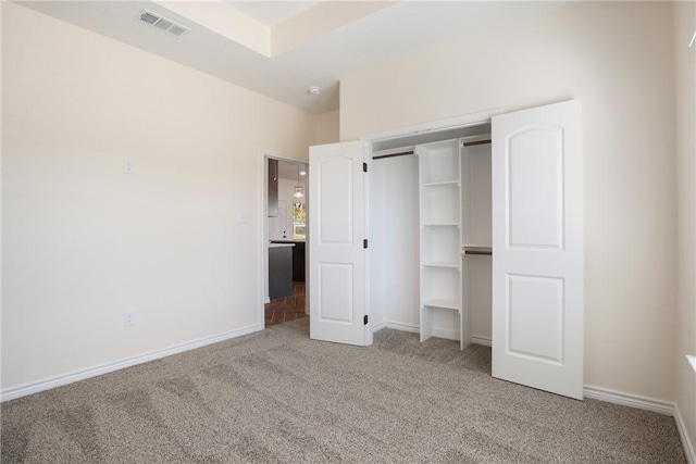 unfurnished bedroom with a closet and carpet