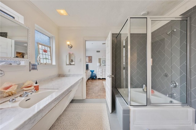 bathroom with vanity, combined bath / shower with glass door, ornamental molding, and tile patterned floors