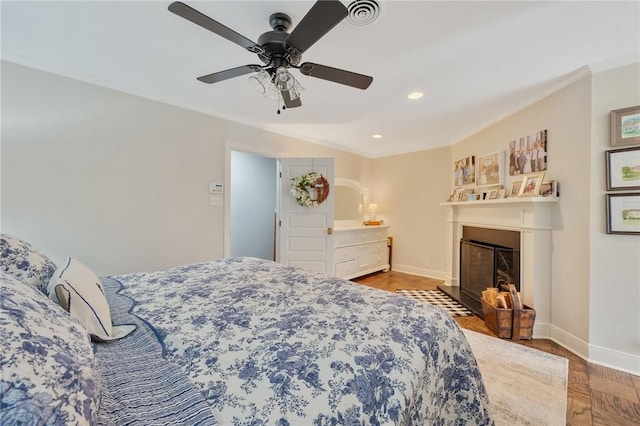 bedroom with ceiling fan and ornamental molding