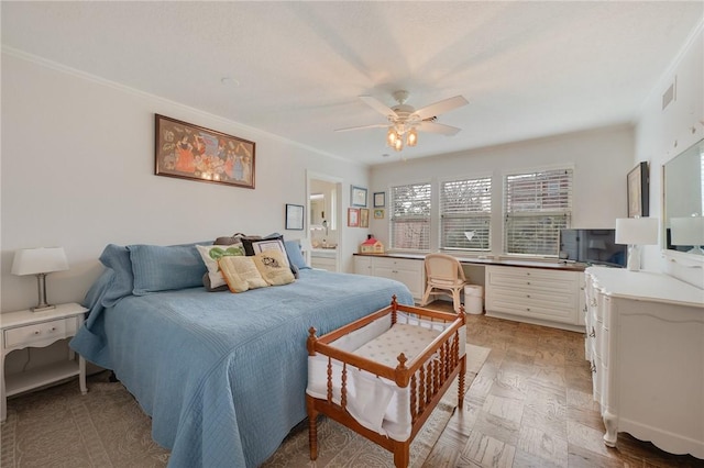 bedroom featuring crown molding, ceiling fan, and ensuite bathroom