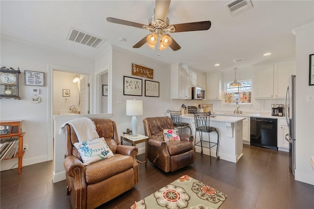 living room featuring ceiling fan, dark hardwood / wood-style floors, and sink