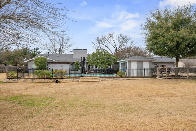 view of yard with a garage and a swimming pool