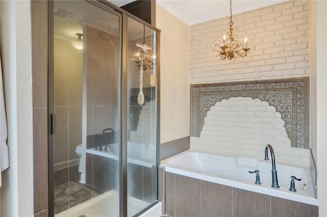 bathroom featuring shower with separate bathtub and an inviting chandelier