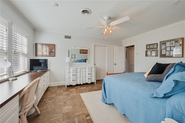 bedroom featuring parquet floors, ceiling fan, ornamental molding, and a closet