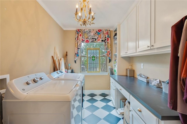 clothes washing area featuring cabinets, ornamental molding, a chandelier, and washing machine and dryer