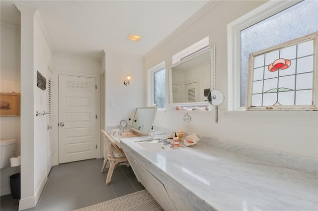 bathroom with crown molding and tile patterned flooring