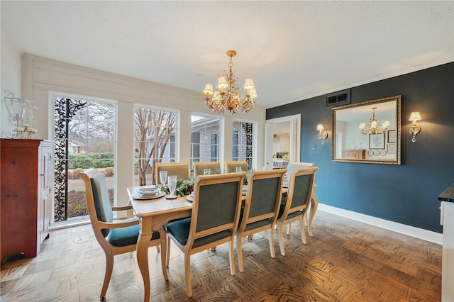 dining space with a notable chandelier and parquet floors