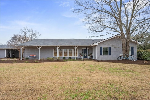 rear view of property featuring a lawn