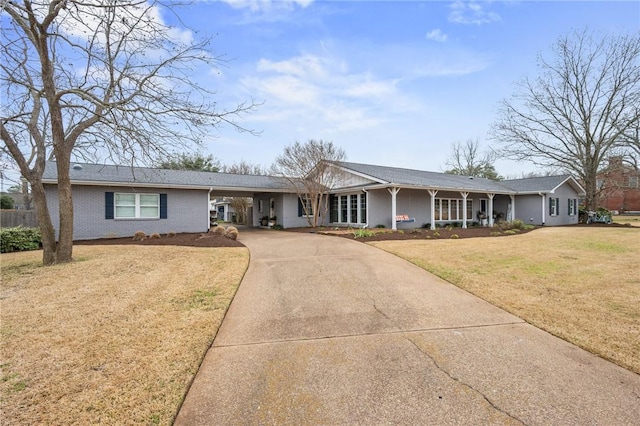 ranch-style house with a carport and a front lawn