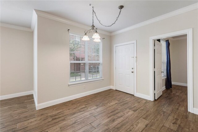 801 Luther St W Unit 307, College Station, TX 77840 - unfurnished dining area featuring wood finished floors, crown molding, a chandelier, and baseboards
