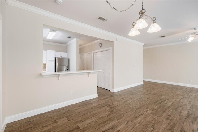 801 Luther St W Unit 307, College Station, TX 77840 - unfurnished living room with wood finished floors, baseboards, ornamental molding, and a ceiling fan