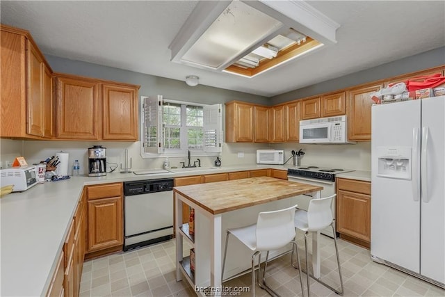 2308 Carnation Ct, College Station, TX 77840 - kitchen featuring white appliances, a sink, light flooring, and butcher block counters