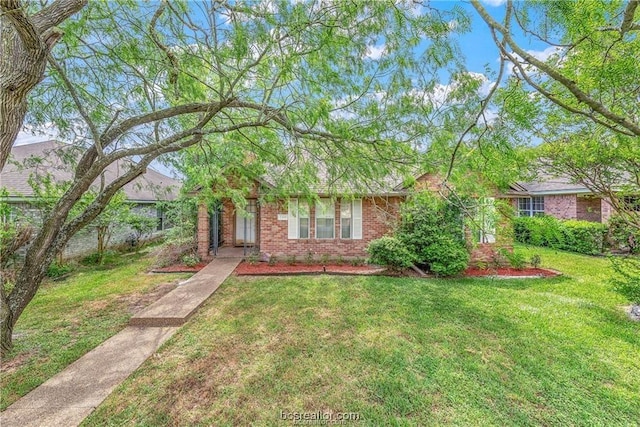 2308 Carnation Ct, College Station, TX 77840 - obstructed view of property with brick siding and a front lawn
