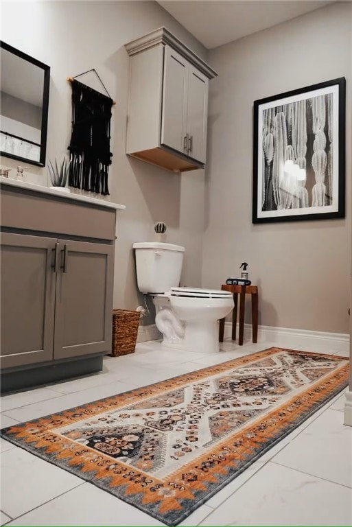 301 W 31st St Unit 103, Bryan, TX 77803 - bathroom with vanity, baseboards, and toilet