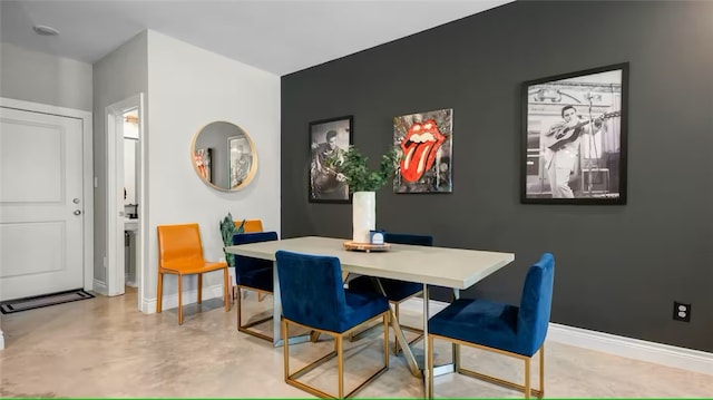 301 W 31st St Unit 103, Bryan, TX 77803 - dining area with baseboards and concrete flooring