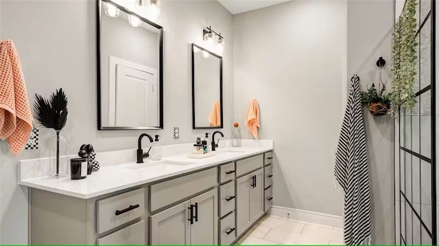 301 W 31st St Unit 103, Bryan, TX 77803 - full bath with a sink, baseboards, and double vanity