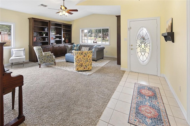 tiled foyer featuring ceiling fan and lofted ceiling