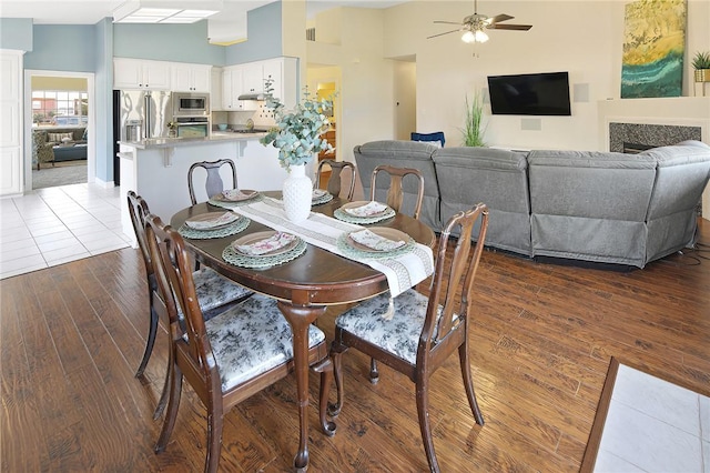 dining area featuring ceiling fan, dark hardwood / wood-style flooring, and lofted ceiling