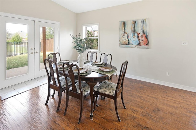 dining area with french doors, vaulted ceiling, and hardwood / wood-style floors