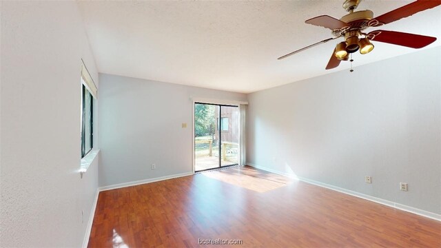 unfurnished room featuring ceiling fan, baseboards, and wood finished floors