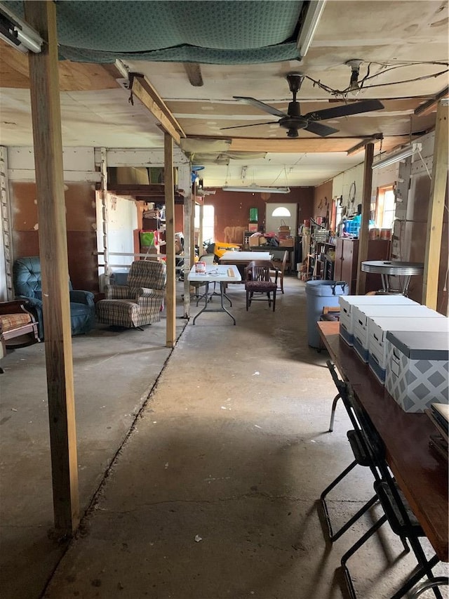 miscellaneous room featuring a ceiling fan and unfinished concrete floors