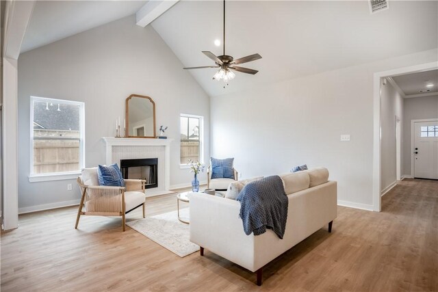 kitchen featuring sink, light hardwood / wood-style floors, pendant lighting, a kitchen island, and appliances with stainless steel finishes