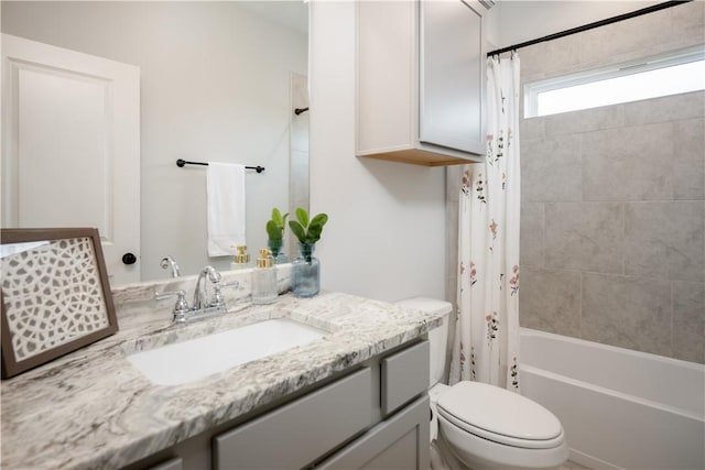 full bathroom featuring shower / bath combo, vanity, and toilet