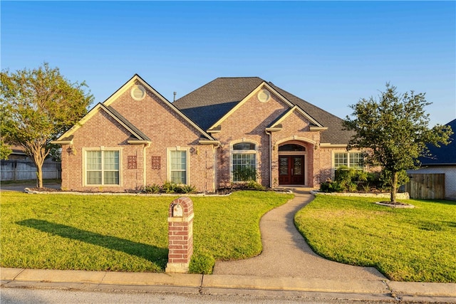 view of front of property with a front lawn and french doors