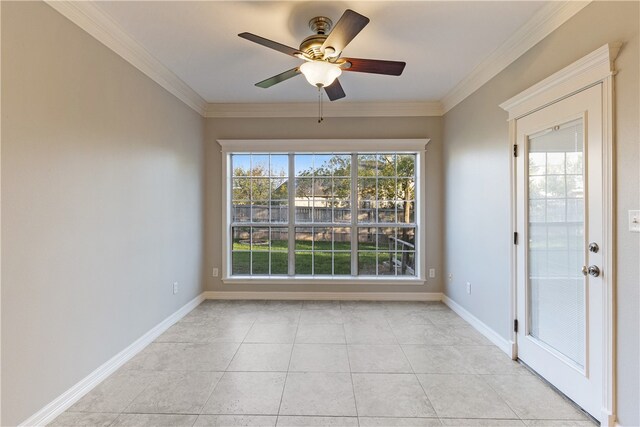 empty room featuring ceiling fan, light tile patterned flooring, and ornamental molding