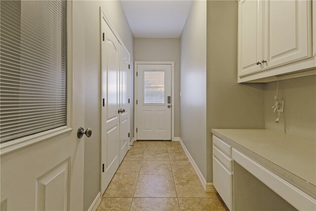 entryway with light tile patterned floors