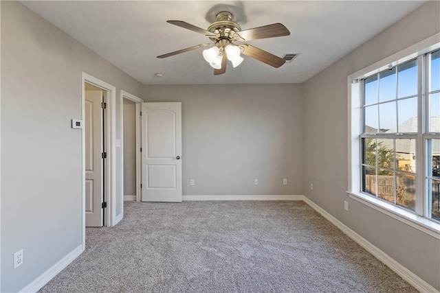 carpeted empty room with ceiling fan