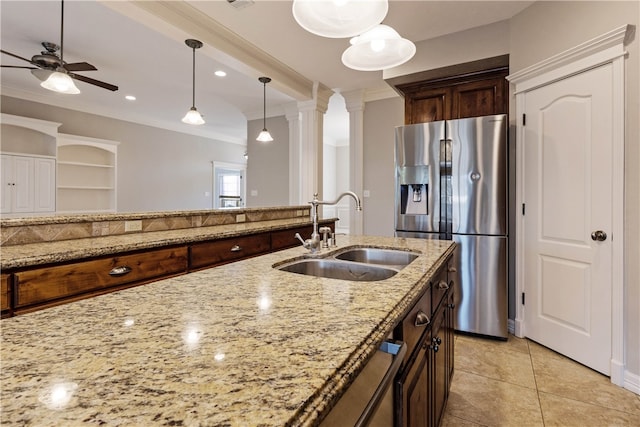 kitchen with stainless steel fridge with ice dispenser, sink, light stone counters, and ornamental molding