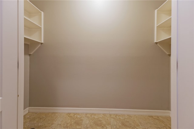 walk in closet featuring light tile patterned flooring