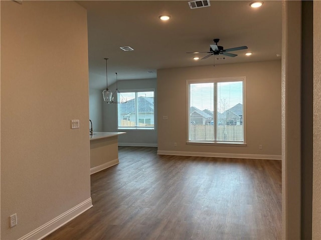 unfurnished room featuring ceiling fan and dark hardwood / wood-style flooring