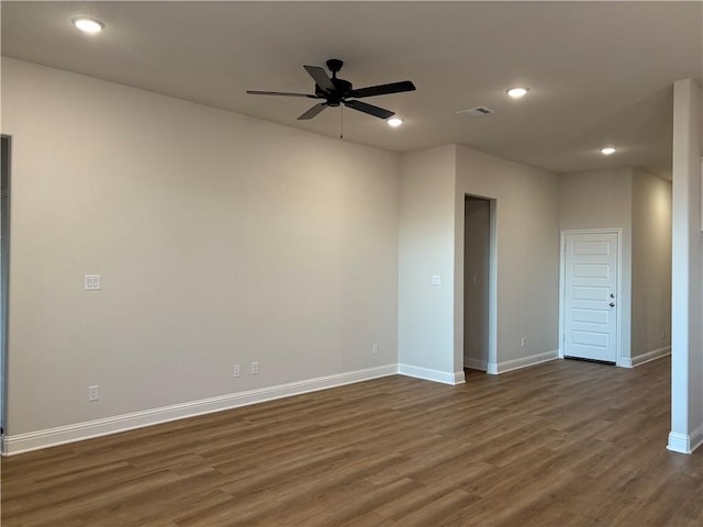 unfurnished room with ceiling fan and dark wood-type flooring