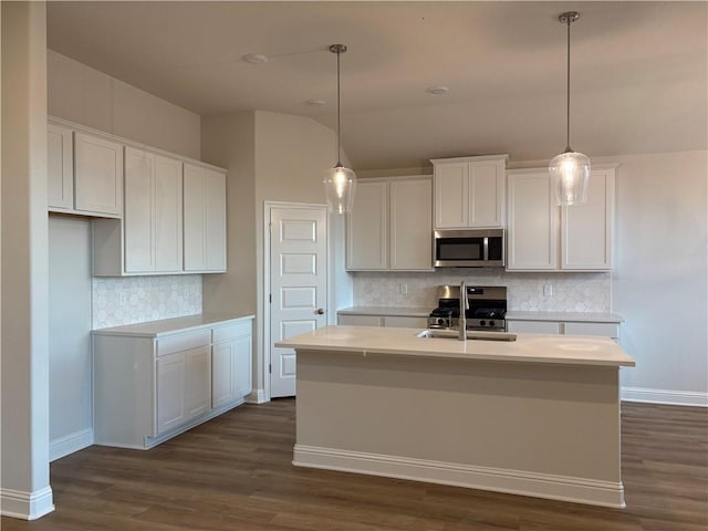 kitchen featuring white cabinetry, a center island with sink, hanging light fixtures, and appliances with stainless steel finishes