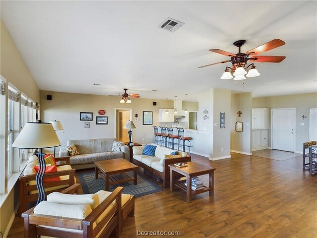 living room with ceiling fan and dark hardwood / wood-style flooring