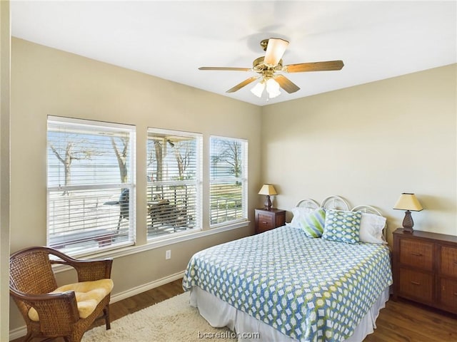 bedroom featuring dark hardwood / wood-style flooring and ceiling fan