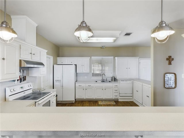 kitchen with white appliances, dark wood-type flooring, sink, white cabinets, and hanging light fixtures