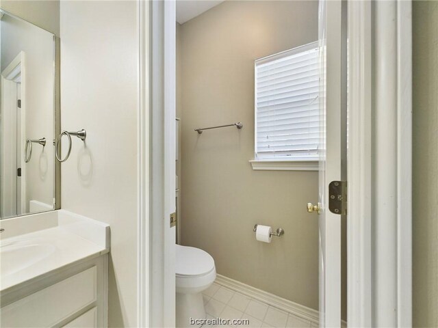 bathroom featuring tile patterned floors, vanity, and toilet