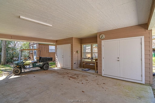 exterior space featuring concrete floors and wood walls