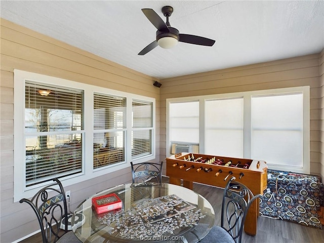 sunroom featuring ceiling fan and cooling unit