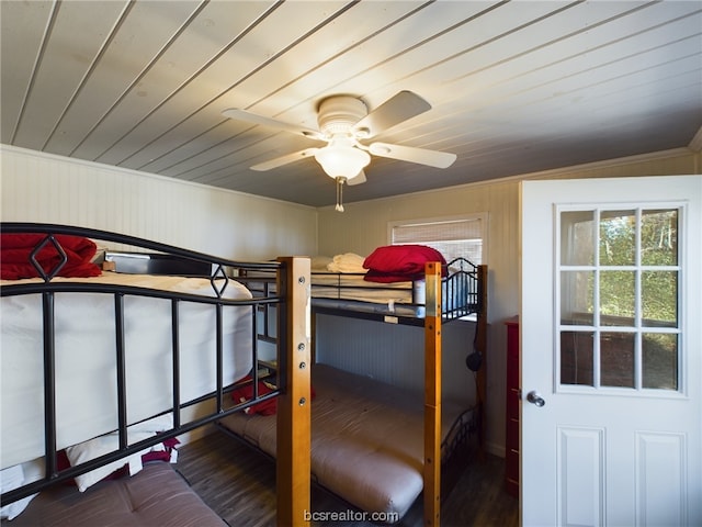 bedroom featuring ceiling fan, crown molding, wood-type flooring, and lofted ceiling